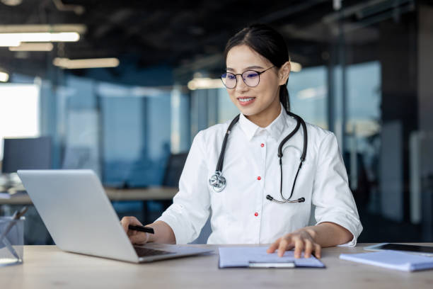 istock Confident female doctor using laptop in modern office 2157076681