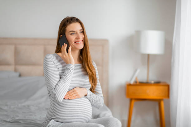 istock Pregnant lady having a phone conversation 2157077782