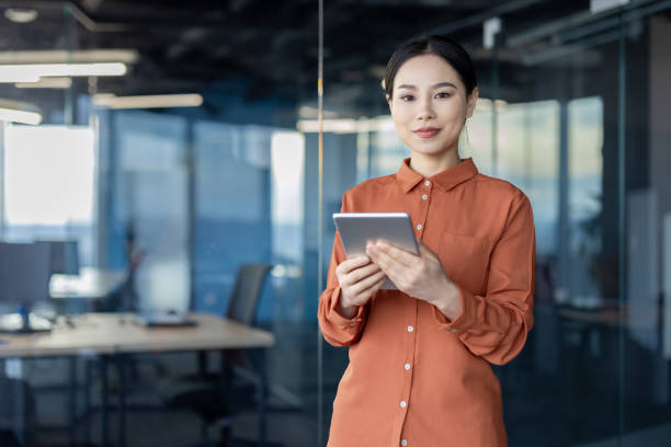 istock Confident businesswoman using a tablet in modern office 2157079472