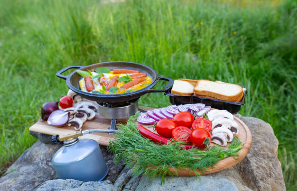 istock Cooking food in a frying pan while camping. 2157080316
