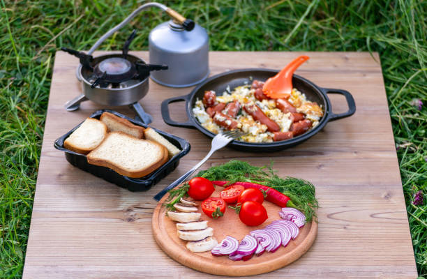 istock Cooking food in a frying pan while camping. 2157080325