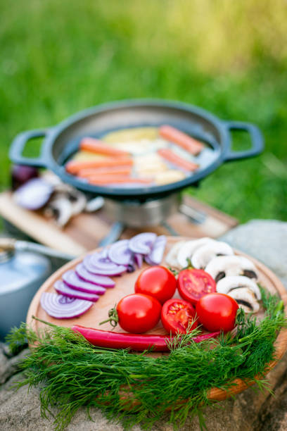 istock Cooking food in a frying pan while camping. 2157080343