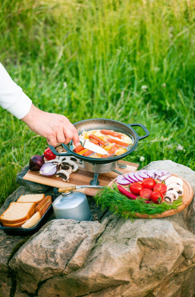 istock Cooking food in a frying pan while camping. 2157080348