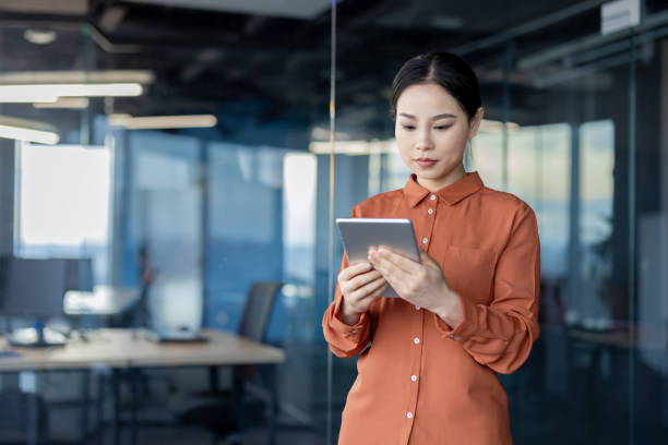 istock Serious businesswoman thinking and working on a digital tablet in a modern office 2157081790