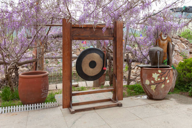 Ornate black and gold gong on wooden frame displayed inside a temple in Ayutthaya, Thailand