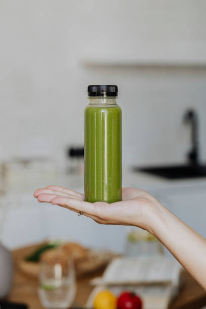 istock Woman holding a bottle of celery juice 2157082380