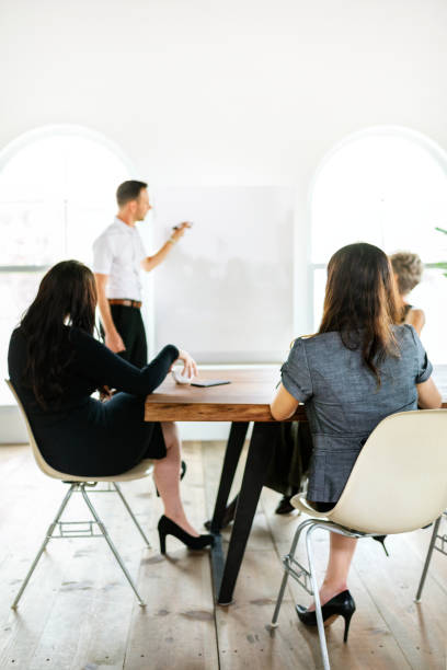 istock Businessman writing on a board in the meeting room 2157082936