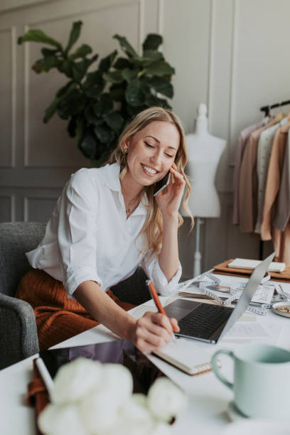 istock Fashion designer on the phone in the studio 2157083601