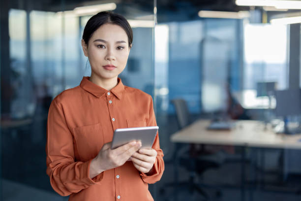 istock Confident businesswoman using digital tablet in modern office environment 2157083777