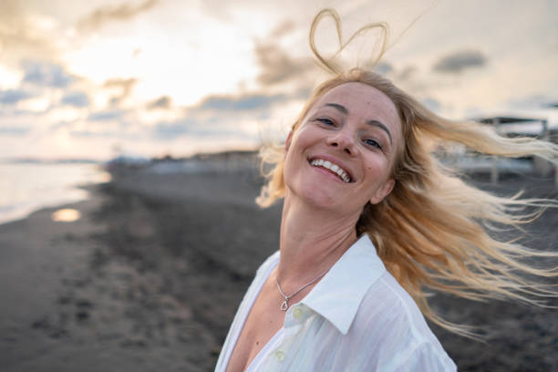 istock Woman having fun on summer vacation on the beach 2157084600