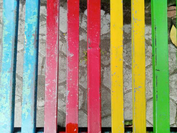 Multi colored old wooden fence on a sunny day.