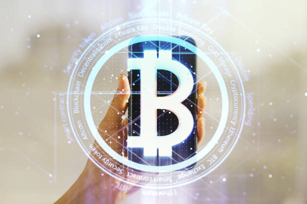 istock Double exposure of creative Bitcoin symbol and hand with cell phone on background. Cryptocurrency concept 2157087110