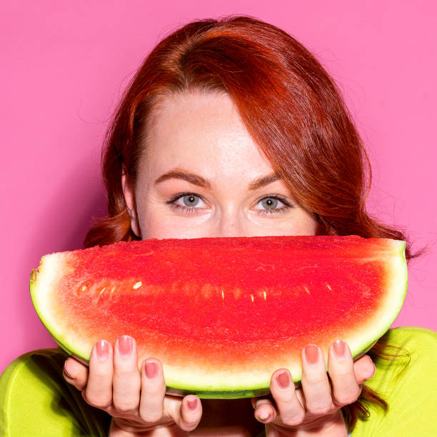 istock Woman holding a watermelon over her mouth 2157087775