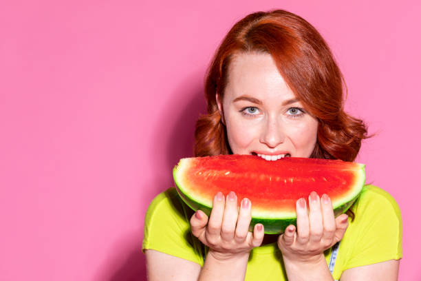 istock Woman biting into a slice of watermelon 2157087783