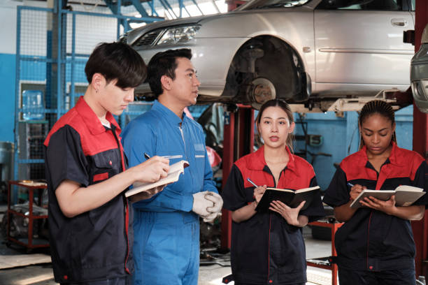 istock A supervisor engineer is training mechanic workers about car repair at a garage. 2157088336