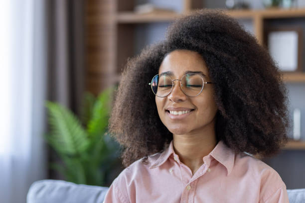 istock Young woman practicing mindfulness meditation at home, feeling relaxed and happy 2157089029