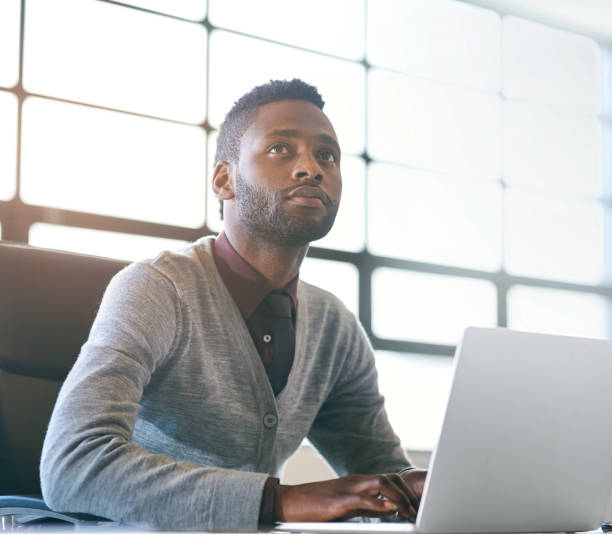 istock Business, thinking and black man with laptop, ideas and opportunity with decision, solution and choice. African person, web designer or employee with computer, thoughts or problem solving for project 2157093469