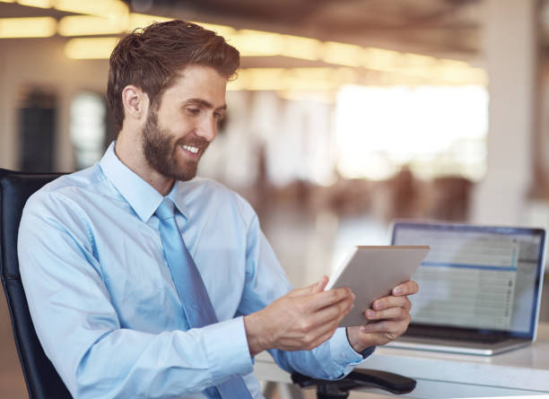 istock Man, business and smile with tablet in office for research, schedule and idea for development of company as entrepreneur. Happy, male person and digital tech for agenda, reading and email at work 2157093490