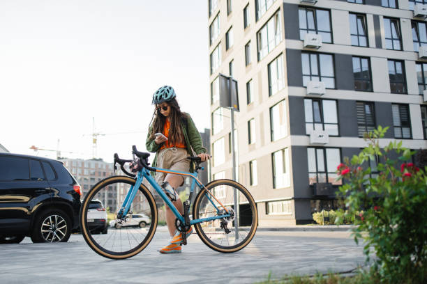 istock Stylish Young Woman Cyclist Using Smartphone in Urban Setting 2157094814