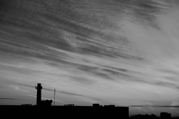 istock Cityscape silhouette with streaky clouds at dusk 2157094890