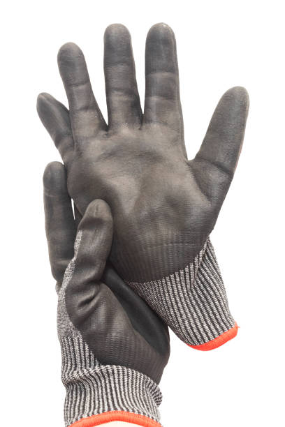 istock Hand wearing a black work glove holds another glove on a background. Working hand. 2157096822