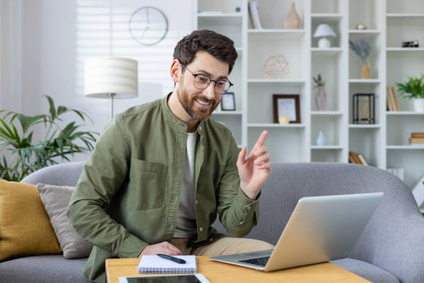 istock Smiling man conducting an online video class from his living room 2157097829