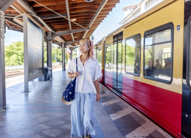 istock Woman commuter walking by train on railway platform 2157101117