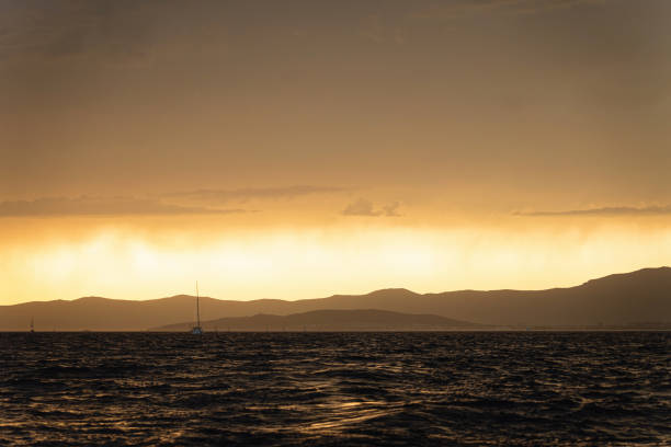 Shot of the sea in the calm of the day while the sun is setting down