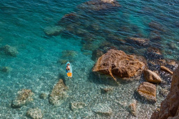 istock Enjoying the paddle board at sea 2157101892