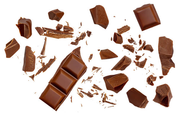 istock Broken chocolate bar pieces falling on isolated white background. Milk Chocolate explosion with  cocoa crumbs and shavings,  Top view. Flat lay. Pattern 2157103483