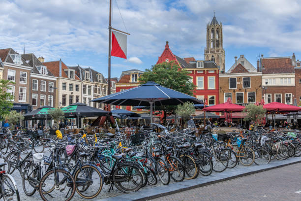 Utrecht, the Netherlands. 29 May 2024. Neude square on a busy evening, the square is full of bicycles and the terrace is full of people, dom tower in the background