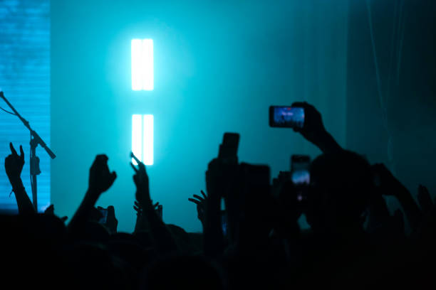 istock Crowd at Concert with Neon Lights and Smartphones 2157103522