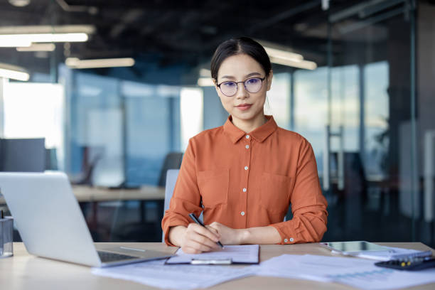 istock Serious thinking businesswoman working in a modern office environment 2157106553