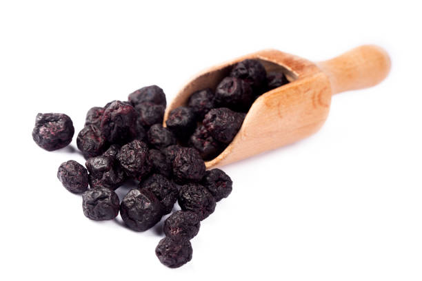 Dried aronia berries isolated on white background