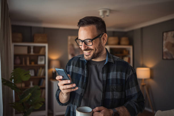 istock My mornings start like this, I actively use my mobile phone and drink my morning coffee 2157109178
