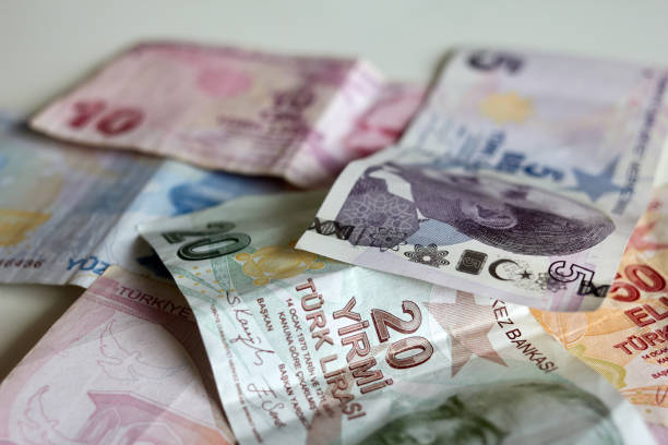 istock Ankara, Turkey - 04 06 2023: Turkish lira banknotes of different denominations on a white background 2157111144