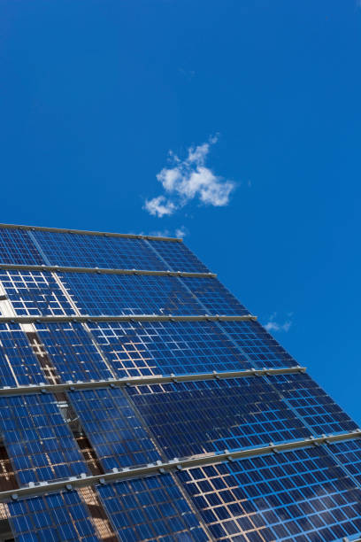 Photo voltaic solar panels and blue sky with clouds