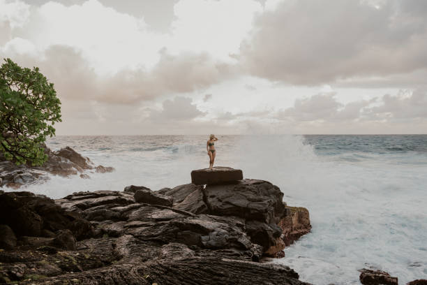istock Woman on rocky coastline 2157111277