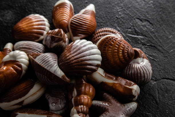 istock Chocolate candies in the shape of shells on a dark background 2157112825
