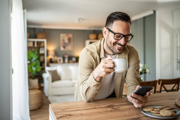 istock Portrait of a middle-aged man using a smartphone at home 2157113533