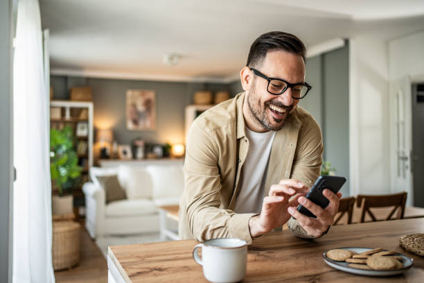 istock Portrait of a middle-aged man using a smartphone at home 2157113540