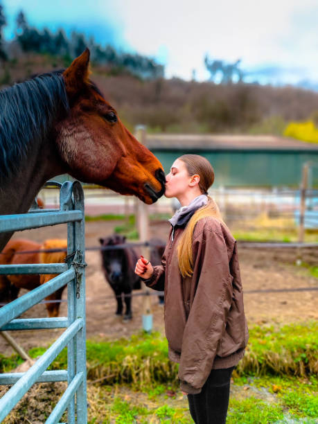 A young lady showing absolute love and admiration to her gorgeous horse