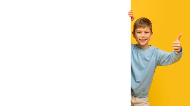 istock Young boy giving thumbs up with copy space 2157118389