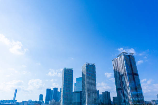 Tower apartments lined up along the river and a refreshing blue sky