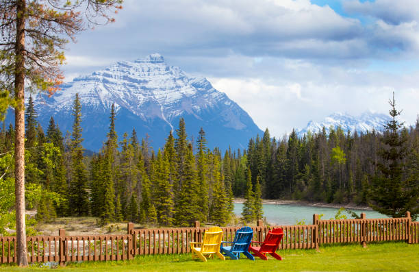 Scenic view of colourful chairs along a mountain river, Jasper National Park