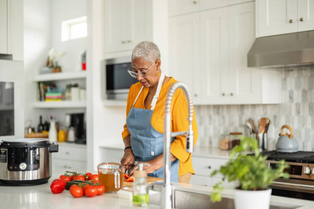 istock Senior Woman Prepares Meal in Modern Kitchen 2157124911