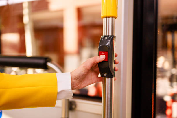 istock Unrecognizable woman's hand pressing stop button on city bus. Concept of commuting. 2157126284