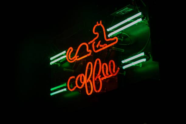 istock Neon sign with the word 'coffee' and a cat image glowing in the dark 2157130007