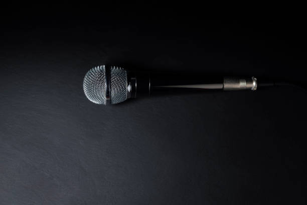istock Black and silver microphones in the studio on a black and dark background. Professional recording equipment. Top view. 2157130673