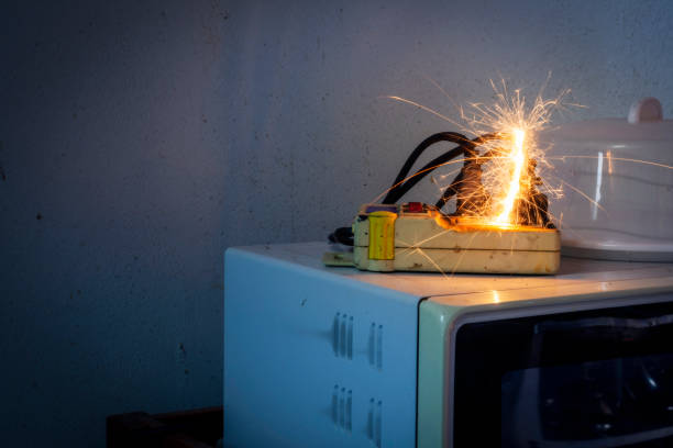istock An electric shork from a microwave outlet causes a spark. Dangerous concept of using old electrical appliances and without quality Therefore it is dangerous to life and property. 2157130680